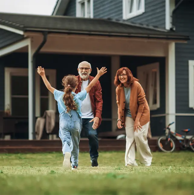 granddaughter running toward her grandparents in their backyard keys to a successful retirement