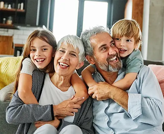 portrait of grandparents with their grandkids in their living room life insurance for retirement