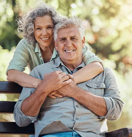 portrait of retired couple on park bench
