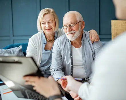 retirees meeting with financial advisor about keys to a successful retirement